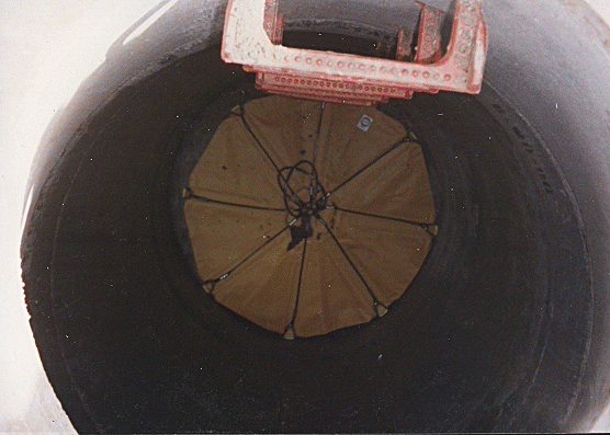 Grappler Debris Catcher in a manhole, catching falling debris
