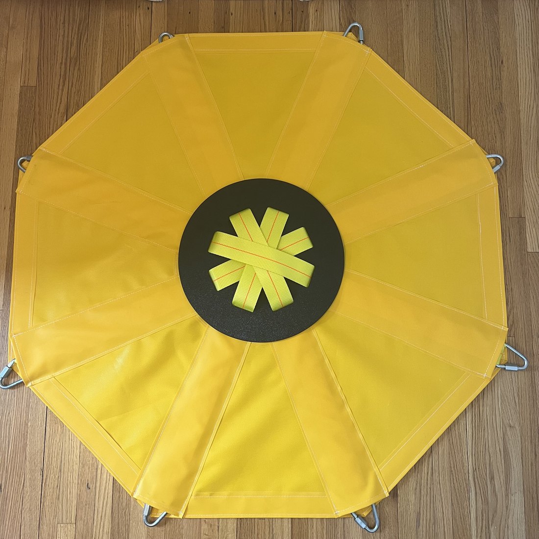 The underside of the Manhole Debris Catcher, seen from above, with the centre plate where the grappling sphere attaches